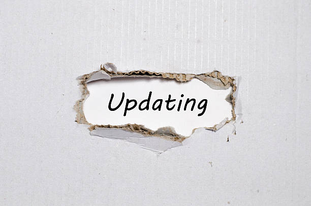 istock The word updating appearing behind torn paper 627977308