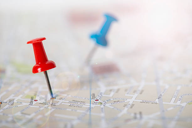 istock Red and blue push pin stuck in a street map 627977690