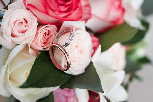 istock wedding rings on a wedding bouquet. 627978030