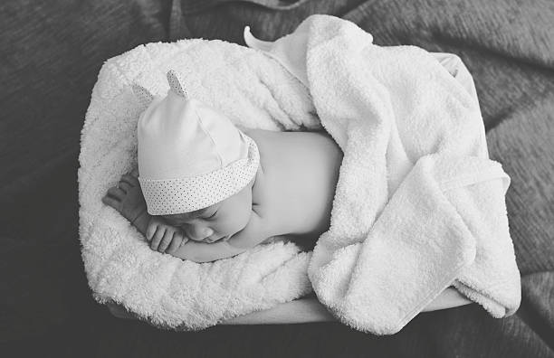 istock Newborn sleeping in blanket and sing Hello 627984284