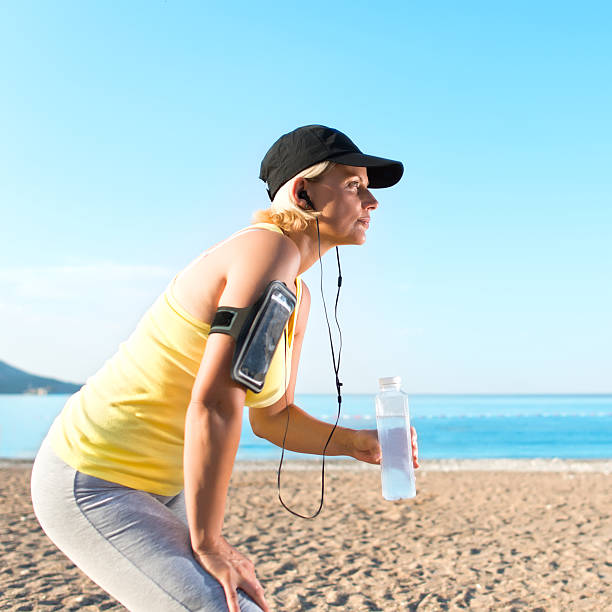 istock Woman drinking water after jogging 627984432