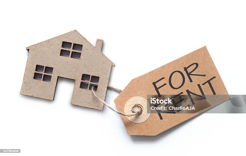 House shape with rental label Label attached to miniature house over a white background House Rental Stock Photo