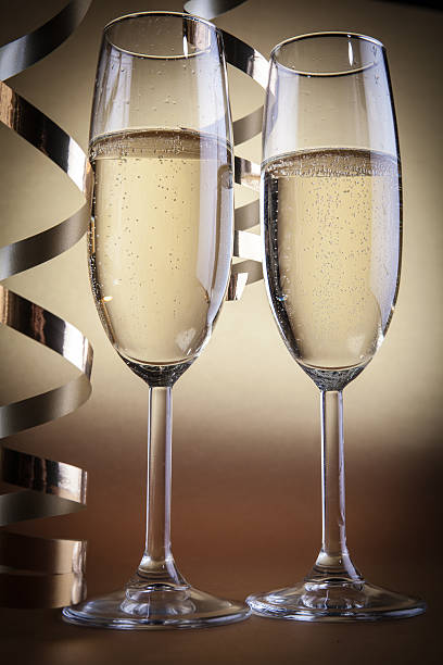 istock Two champagne glasses, on golden background 627984842