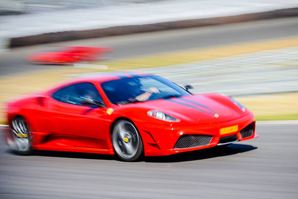 Ferrari F430 Scuderia Italian V8 sports car driving fast Zandvoort, The Netherlands - June 29, 2014: Ferrari F430 Scuderia sports car driving on the Zandvoort race track during the 2014 Italia a Zandvoort day. ferrari ferrari f430 italian culture action stock pictures, royalty-free photos & images