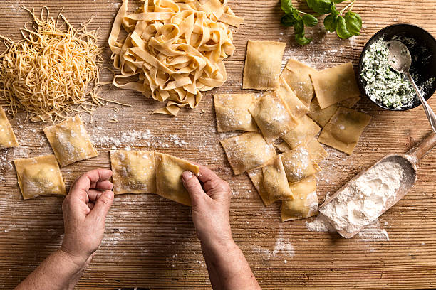 Woman making pasta Woman making homemade pasta. pasta stock pictures, royalty-free photos & images