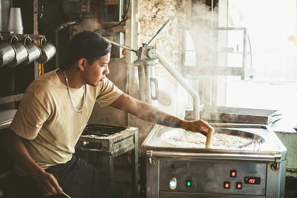 Mexican Cook Frying Churros in a Coffeeshop.
