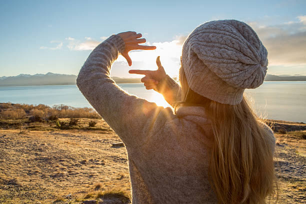 istock Young woman framing landscape 627994566