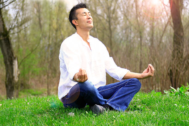 istock Japanese man meditating in the nature 627995732