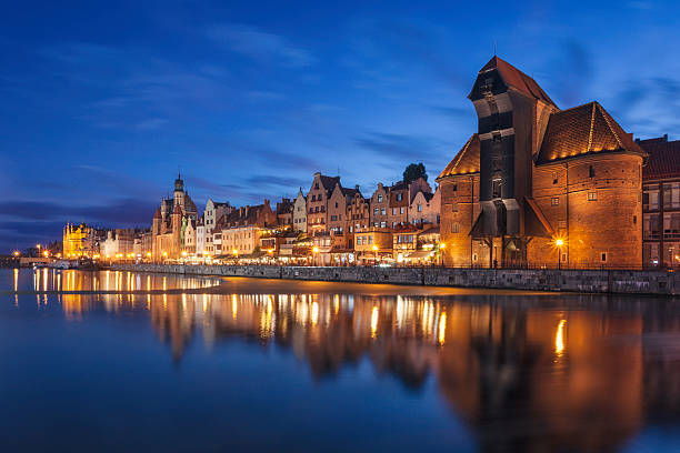 Gdansk old town at night The old town of Gdansk by the Motlawa river in the evening. On the right is a historical wooden crane, a landmark in the city. gdansk photos stock pictures, royalty-free photos & images