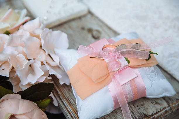 istock Gold wedding rings on white decorate pillow 628003766