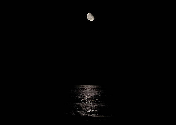 istock Moon reflecting in the Atlantic Ocean on a dark night. 628004580