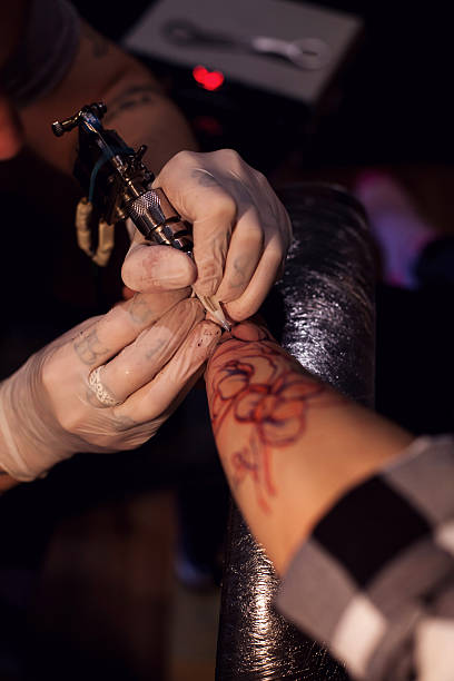 istock Tattoo artist works in salon 628006192