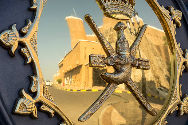 Sultan of Oman Coat of Arms with Al Mirani Fort reflection stock photo