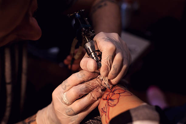 istock Tattoo artist works in salon 628007268