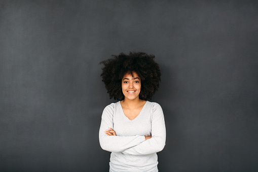 Woman standing in front of a blackboard.