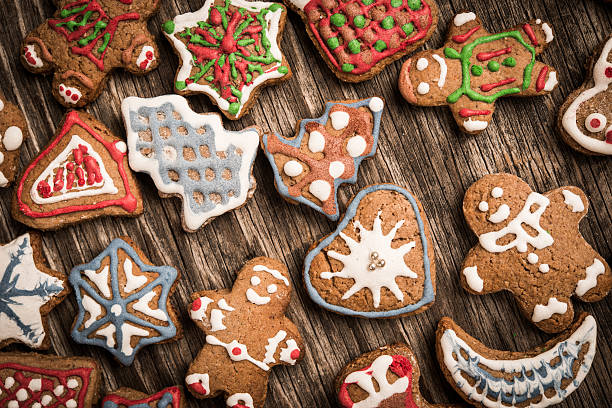 istock Colorfully Christmas cookies on rustic wooden background, gingerman and tree 628014370