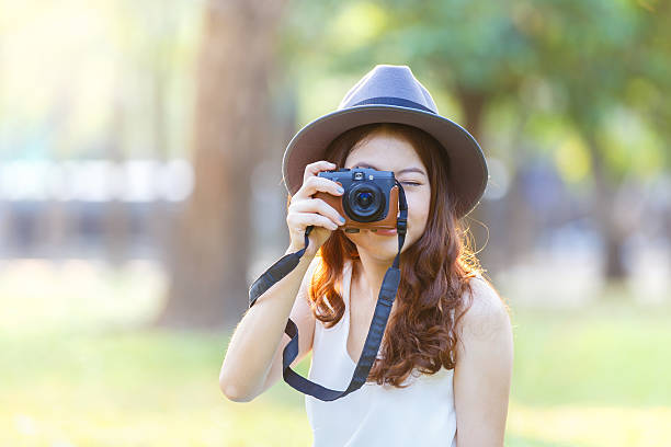 istock Beautiful asian woman looking at view screen camera. 628014826
