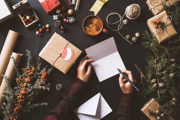 istock Writing New Year Christmas cards, table top flat lay 628015262