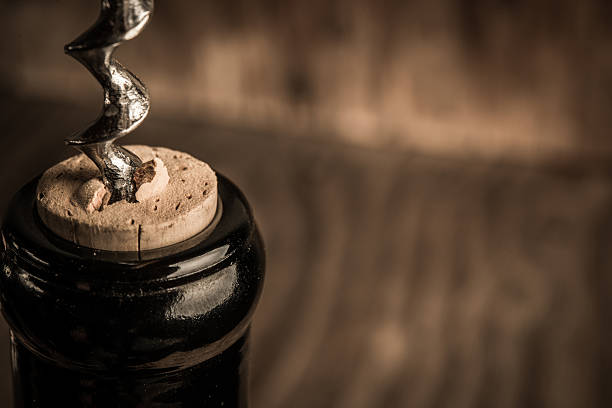 istock Bottle of wine with corkscrew on wooden background 628016264
