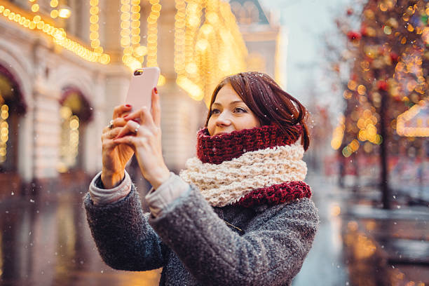 istock Woman with mobile phone on the street 628016318