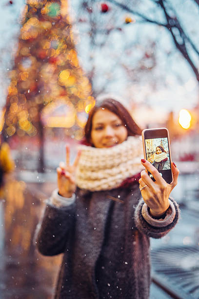 istock Woman taking selfie in front of the christmas tree 628016412