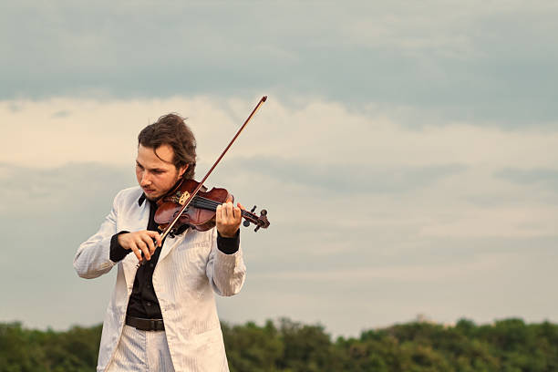 istock Violinist playing the violin outdoors 628016840