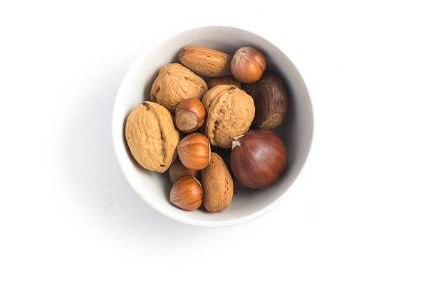 whole nuts into a bowl - healthy eating macro close up nut imagens e fotografias de stock