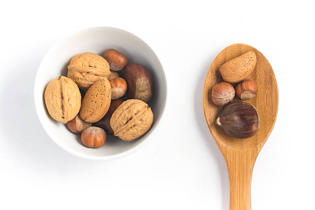 whole nuts into a bowl - healthy eating macro close up nut imagens e fotografias de stock