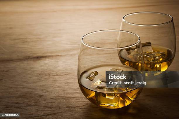 Glass Of Whiskey On Wooden Table Stock Photo - Download Image Now - Dark, Drinking Glass, Glass - Material