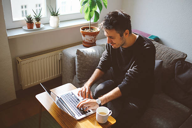 istock Young man doing a freelance job from home 628018280