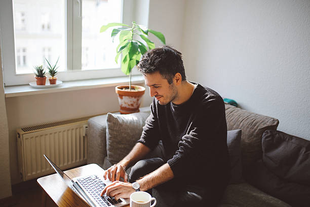 istock Young man doing a freelance job from home 628023556