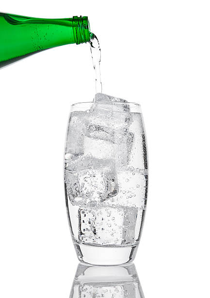 istock Pouring fresh sparkling water from bottle to glass 628024500