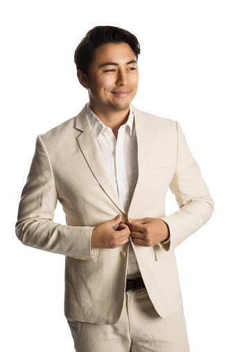 Handsome businessman wearing light colored suit, feeling calm and relaxed smiling. White background.
