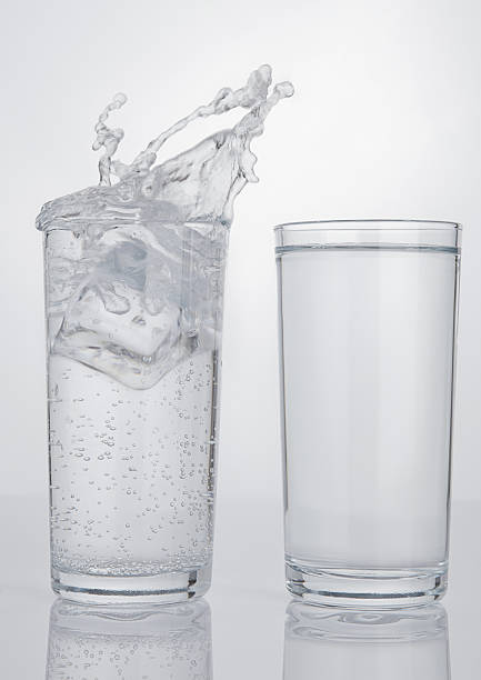 istock Two glasses with sparkling and still splash water 628025040