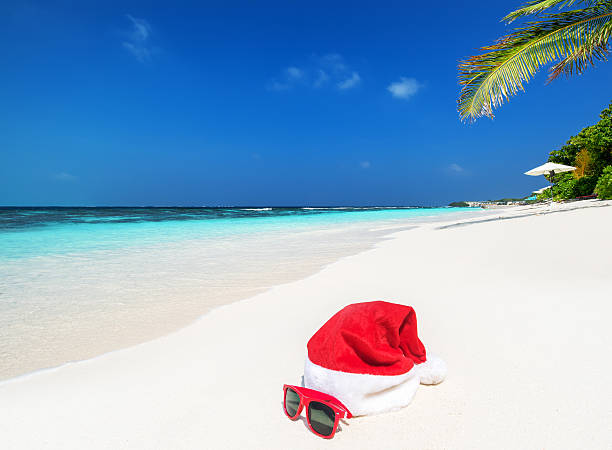 istock Santa hat and sunglasses on the tropical beach 628026256