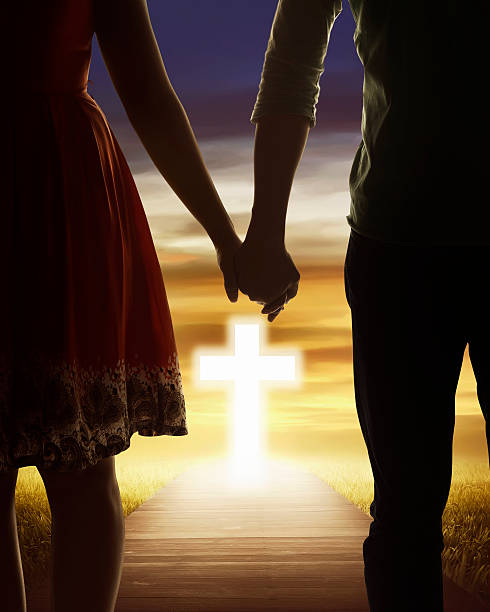 빛나는 십자가를 찾고 젊은 부부 - forgiveness praying men silhouette 뉴스 사진 이미지
