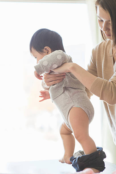 istock Mother changing the baby's clothes 628028920