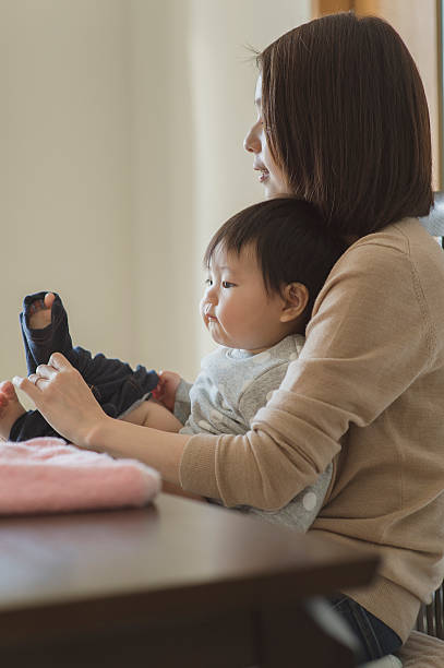 istock Mother changing the baby's clothes 628028956