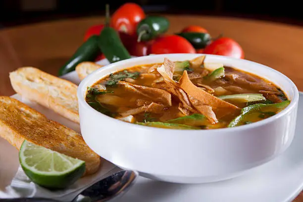 Traditional mexican tortilla soup with bread