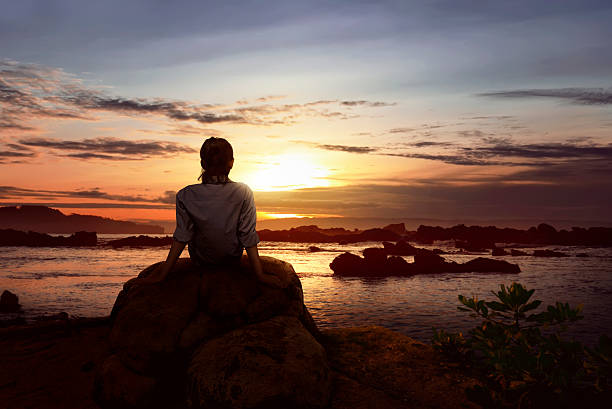 istock Image of woman sitting on the rock 628029656