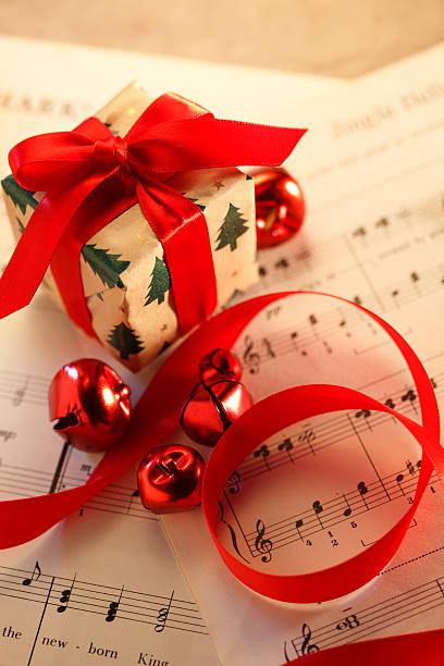 istock Small Present Resting On Christmas Sheet Music 628030634