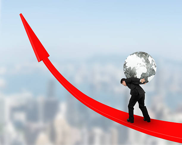 istock Man carrying globe upward on red trend line 628034210