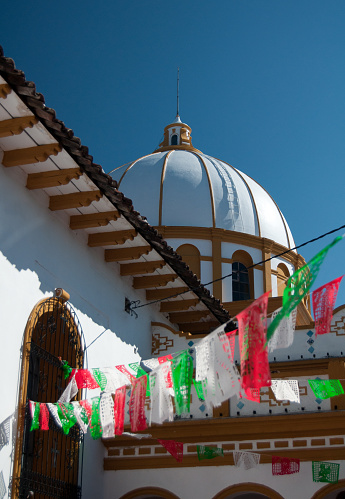 Detail of the Church of Guadalupe in San Cristobal de las Casas with flags