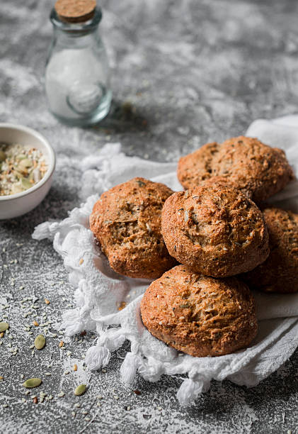 istock Gluten free multi seed bread rolls on a wooden table. 628036280