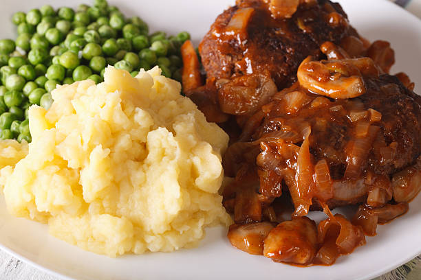 istock Salisbury steak with mashed potatoes and green peas close-up. Horizontal 628037154