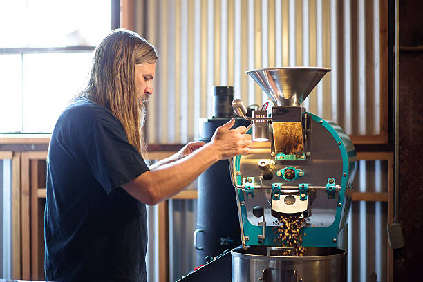 istock Coffee Beans Pouring From Roaster in Small Business 628038734