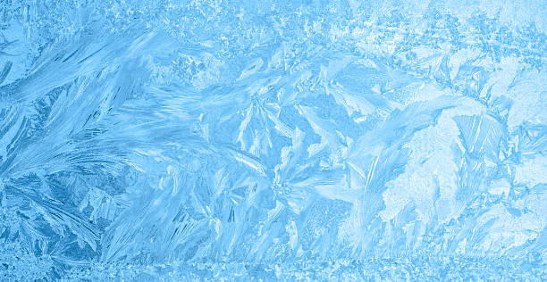 istock beautiful winter ice, blue texture on window, festive background 628038854