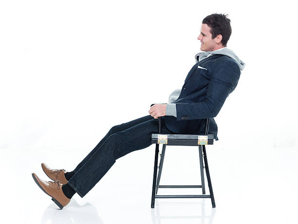 istock Smiling man sitting on chair 628039392