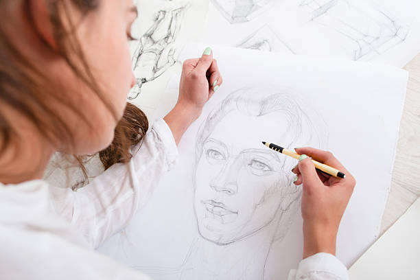 Artist drawing pencil portrait close-up Artist drawing pencil portrait close-up. Woman painter creating picture of woman on big whatman. Art, talent, craft, hobby, occupation concept pencil drawing photos stock pictures, royalty-free photos & images