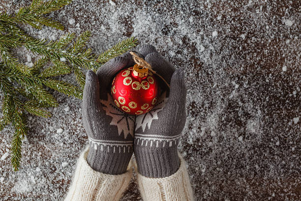 istock Girl hold christmas ball in hands 628065018